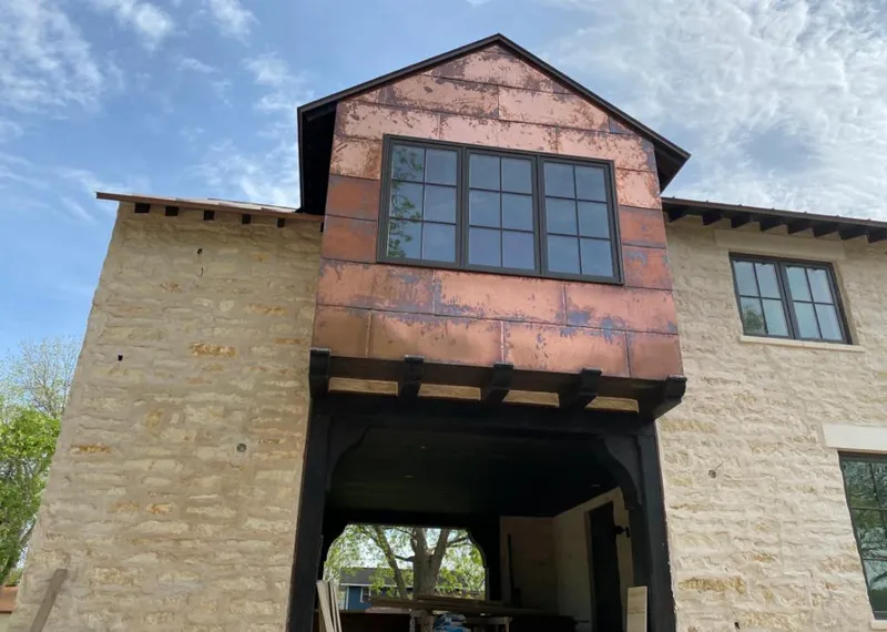 Copper metal panel facade on a stone building for Skylight Installation in Walker Mill